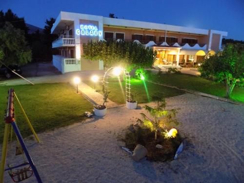 a building with lights in a yard at night at Galaxy Hotel in Argostoli