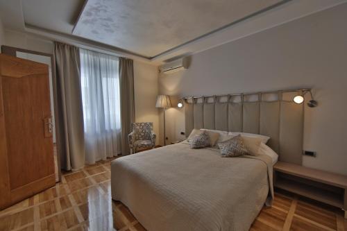 a bedroom with a large bed and a window at Aber Apartment in Belgrade