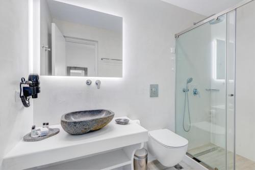 a bathroom with a sink and a glass shower at Makis Place in Tourlos