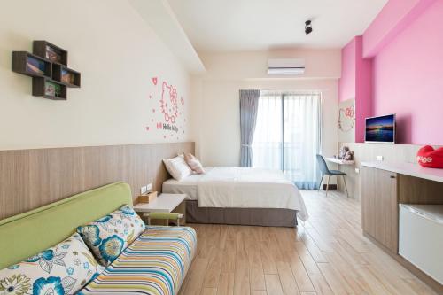 a hotel room with a bed and a couch at Sanwu Homestay in Magong