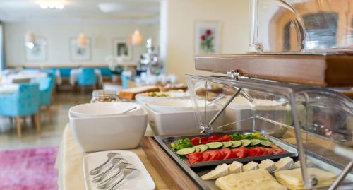 a buffet with food on a table in a restaurant at Villa Christina in Pörtschach am Wörthersee