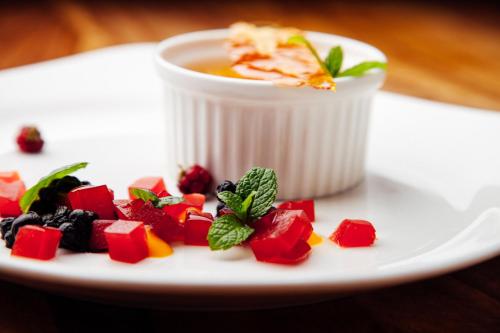 a plate of food with a cup of soup at Four Winds in Krynica Morska