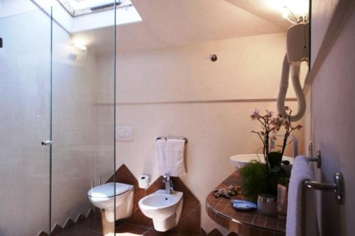 a bathroom with a toilet and a glass shower at Hotel Derby in Bellaria-Igea Marina