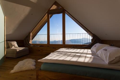 A bed or beds in a room at Eco Chalet AstraMONTANA