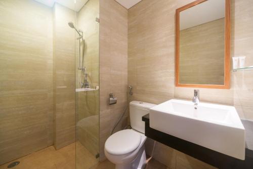 a bathroom with a sink and a toilet and a shower at Sotis Residence Pejompongan in Jakarta