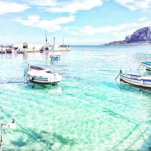 two boats are docked in the water on a beach at Mongibello Palace B&B in Mondello