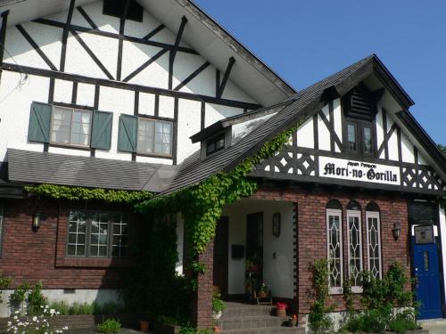 a building with a sign that reads shut up awhile at Country Inn Mori no Gorilla in Kitashiobara