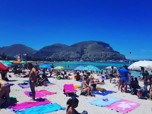 a group of people on the beach at a beach at Mongibello Palace B&B in Mondello
