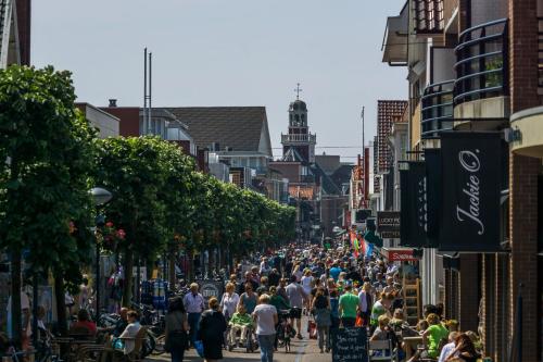 a crowd of people walking down a busy city street at Strandzand in Noordwijk aan Zee