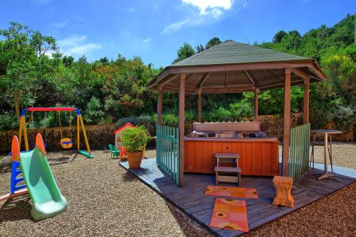 a gazebo with a grill and a playground at Casa Scopeti by PosarelliVillas in Impruneta