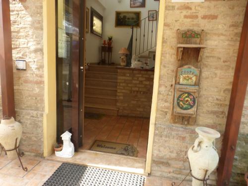 an open door to a room with a staircase at Al Casolare in Corinaldo