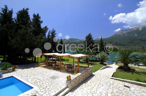 an image of a villa with a swimming pool at Geni Garden Apartments in Yenion