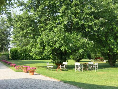 a table and chairs under a tree in a park at Villa Schiavi in Sermide
