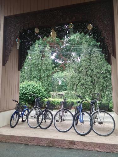 a group of bikes parked in front of a building at Fueng Fah Riverside Gardens Resort in Mae Rim