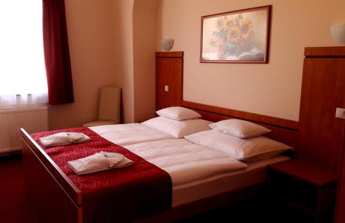 a bedroom with two beds with pillows on it at Diana Club Hotel in Budapest