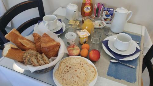 a table with a breakfast of bread and toast at Hôtel de la Côte Fleurie in Deauville