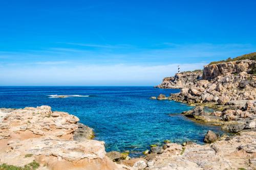 a view of the ocean from a rocky cliff at Barceló Portinatx - Adults Only in Portinatx