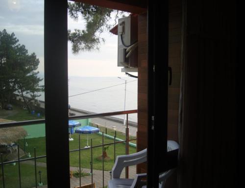 a room with a view of the ocean from a window at Guest House Rusalka in K'obulet'i
