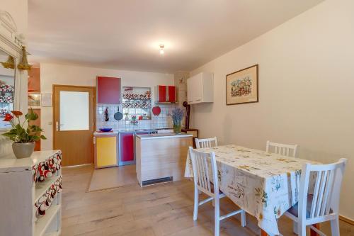 - une cuisine et une salle à manger avec une table et des chaises dans l'établissement Apartment Matija, à Čunski