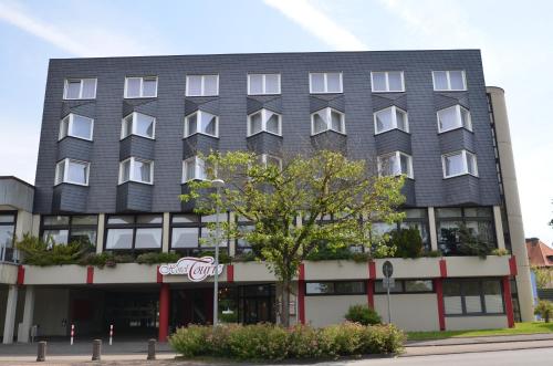 an apartment building with a black roof at Hotel Touric in Korbach
