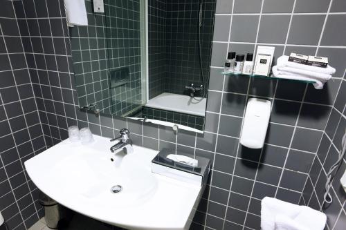 a bathroom with a sink and a mirror at Hotel Reykjavík Centrum in Reykjavík