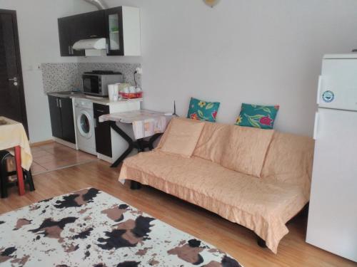 a living room with a couch and a table at Sea Apartment in Burgas