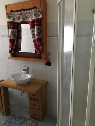 a bathroom with a sink and a mirror at Le samantine in Baceno