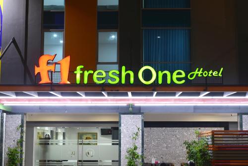 a fresh one hotel sign on the side of a building at Fresh One Hotel in Batam Center