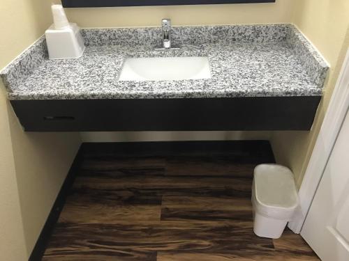 a bathroom with a sink and a toilet at Knights Inn Lumberton in Lumberton