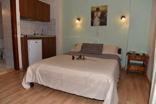 mała sypialnia z łóżkiem i kuchnią w obiekcie 40 Platania Hotel w mieście Loutra Edipsou