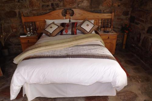 En eller flere senge i et værelse på Verbe Farm Accommodation