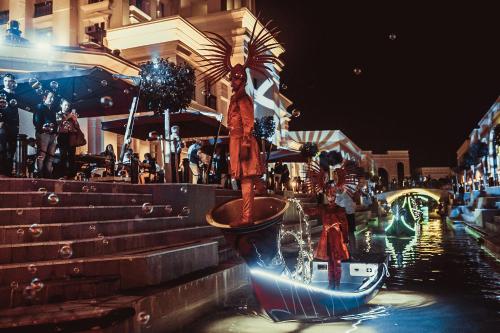 a potted plant in a pot on a canal at night at The Land Of Legends Kingdom Hotel - All-in Concept in Belek