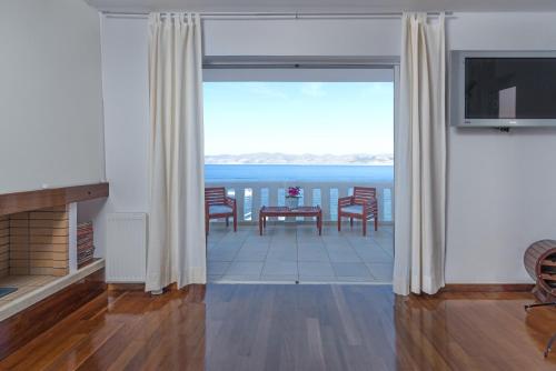 a living room with a view of the ocean at Cape Villa at Sounio in Sounio