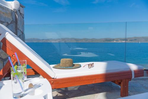 a bed on a boat with a hat on it at Cape Villa at Sounio in Sounio