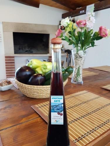 a bottle of wine sitting on top of a table at Apartment Ante in Klek