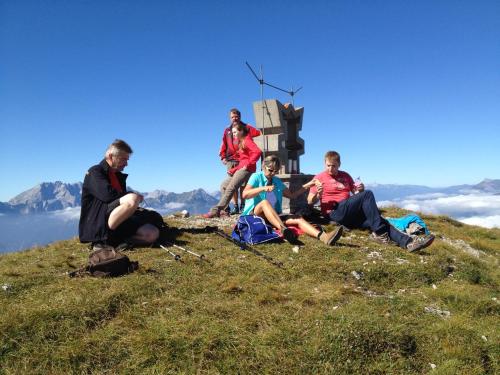 a group of people sitting on top of a mountain at Rauterhof in Hermagor