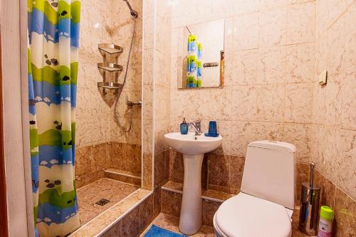 a bathroom with a toilet and a sink and a shower at Bereket in Astana