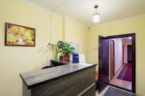 an office with a desk and a painting on the wall at Bereket in Astana
