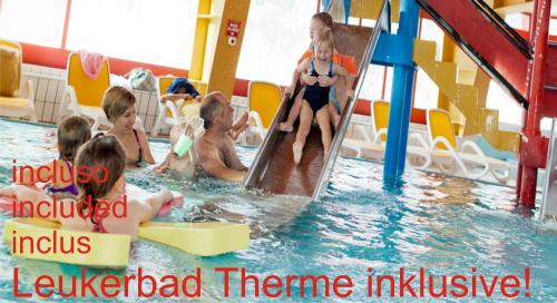 a group of children playing in a swimming pool at Hotel Paradis-Leukerbad-Therme in Leukerbad