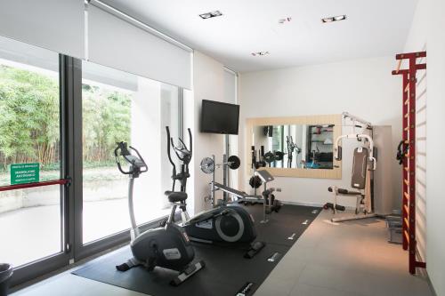 a room with a gym with bikes and a mirror at Zambala Luxury Apartments in Milan