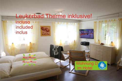 a bedroom with a bed and a desk at Hotel Paradis-Leukerbad-Therme in Leukerbad
