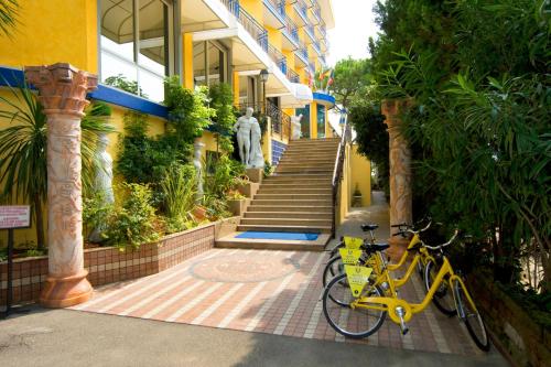 a yellow bike parked in front of a building at Hotel Napoleon in Lido di Jesolo
