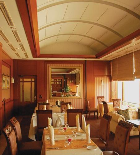a restaurant with tables and chairs in a room at Pearl Continental Hotel, Karachi in Karachi