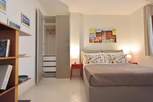 a bedroom with a bed and a side table at Stella Marina in Quartu SantʼElena