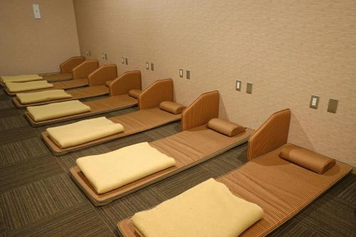 a row of chairs in a waiting room at Mikasa Tennen Onsen Taikonoyu Sparesort Hotel Taiko Bettei Hatago in Iwamizawa