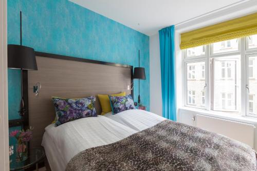 Postel nebo postele na pokoji v ubytování Andersen Boutique Hotel