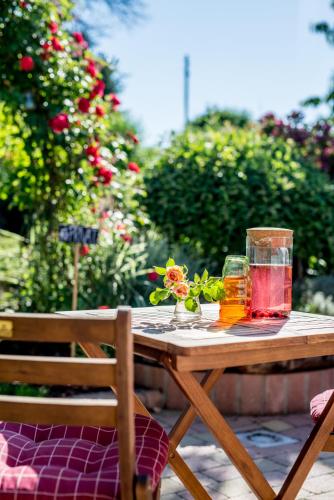 a wooden table with two glasses of tea on it at Penzionek JH in Jindrichuv Hradec