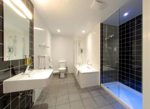 a bathroom with a sink and a shower and a toilet at The Crown Hotel in Harrogate