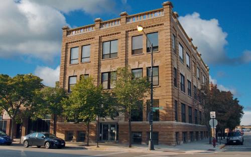a brick building on a street corner with a car parked in front at The Publishing House Bed and Breakfast in Chicago