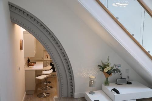 an archway in a stair room with a vanity and a desk at The Chapel Chester - Boutique Apartments in Chester